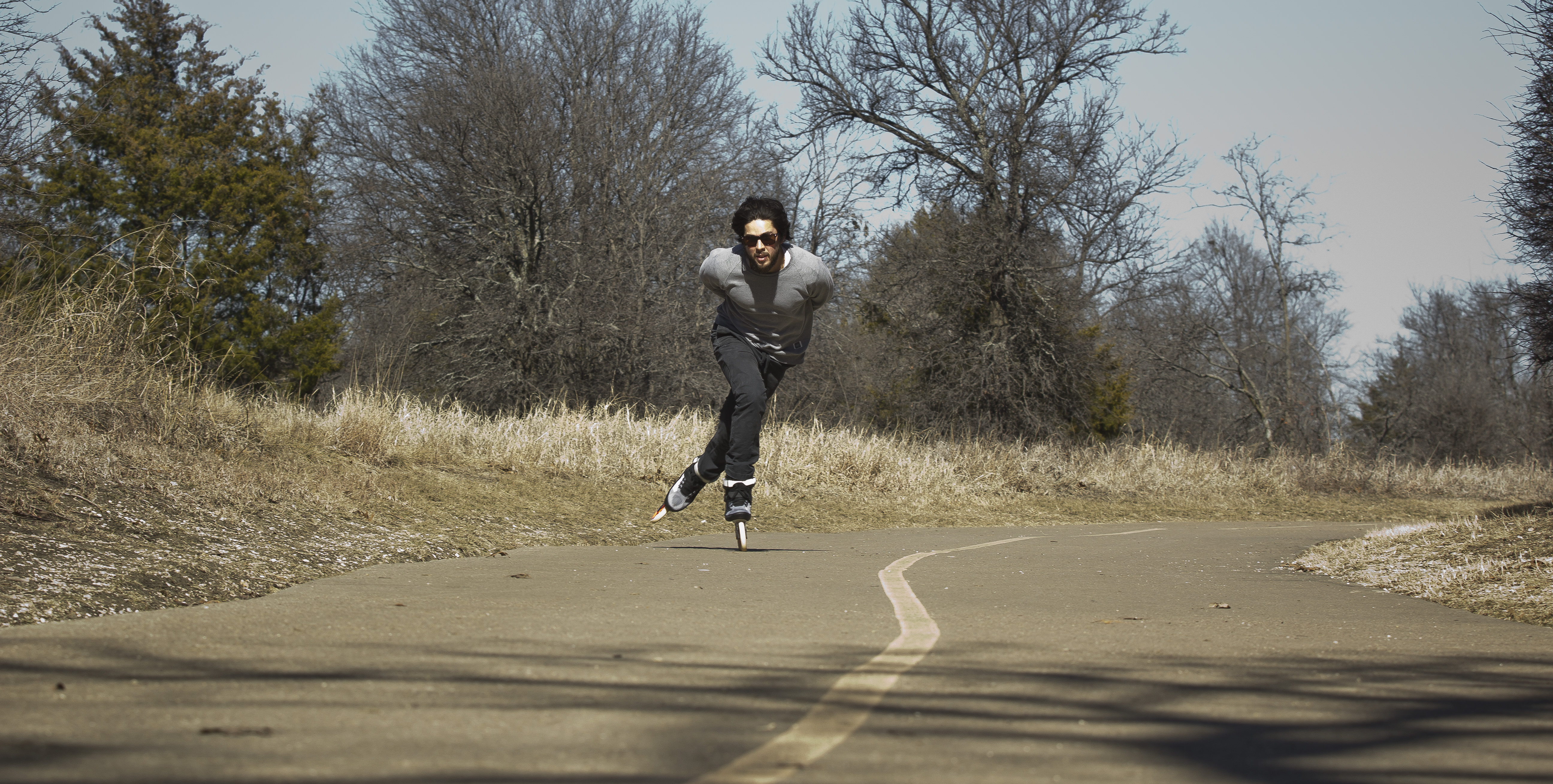 Fritzer owner of Carriers skate shop skating on the trail